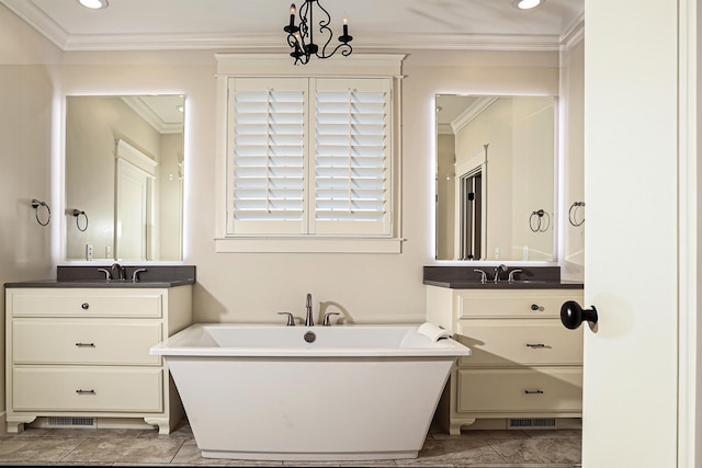 bathroom featuring tile patterned floors, a bathtub, vanity, and a notable chandelier