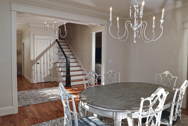 dining room with wood-type flooring, an inviting chandelier, and crown molding