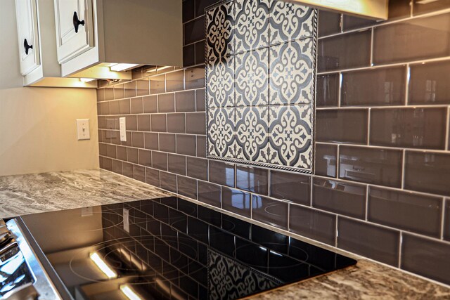 kitchen with white cabinets and decorative backsplash