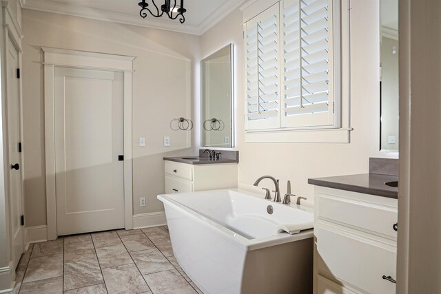 bathroom with a chandelier, vanity, and ornamental molding