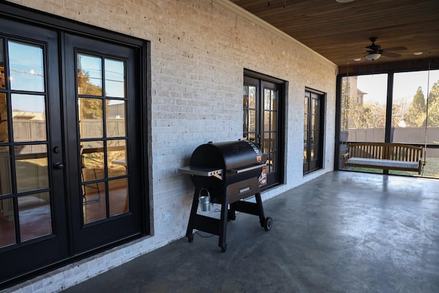 unfurnished sunroom with ceiling fan, wood ceiling, and french doors