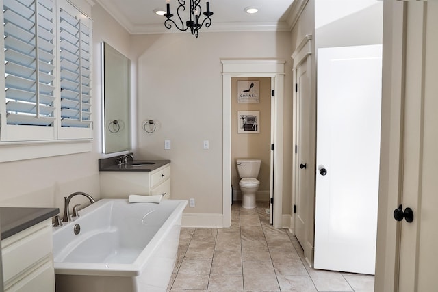 bathroom featuring vanity, crown molding, a chandelier, toilet, and a bathing tub