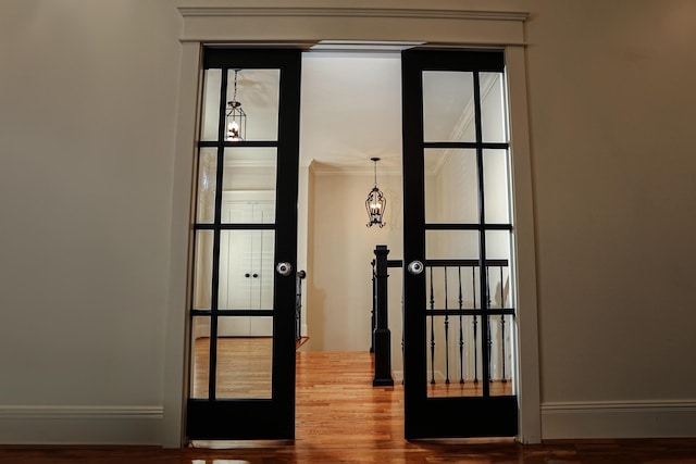 doorway to outside with hardwood / wood-style floors, french doors, and crown molding