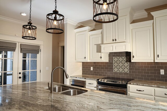 kitchen featuring sink, tasteful backsplash, dark stone counters, decorative light fixtures, and electric stove