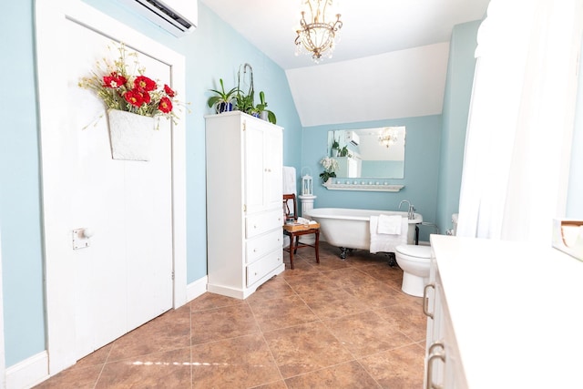 bathroom with a washtub, vanity, vaulted ceiling, a notable chandelier, and toilet