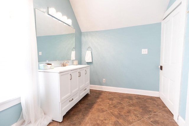 bathroom with vanity and vaulted ceiling