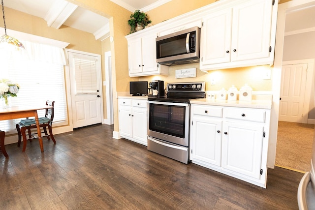 kitchen with appliances with stainless steel finishes, dark wood-type flooring, decorative light fixtures, beamed ceiling, and white cabinetry