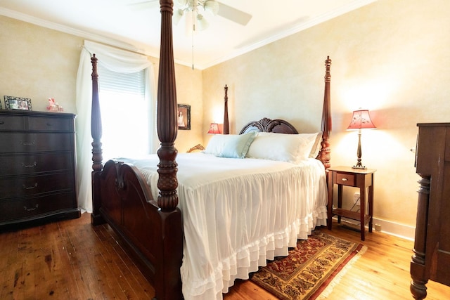 bedroom with ceiling fan, hardwood / wood-style floors, and crown molding