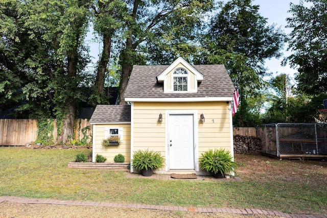 view of outbuilding with a yard