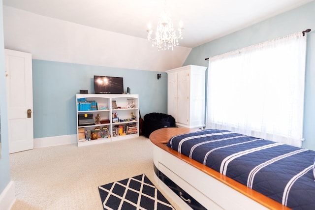 bedroom with a chandelier, carpet floors, and lofted ceiling