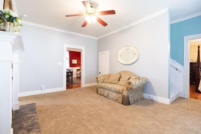 sitting room featuring carpet flooring, ceiling fan, and ornamental molding