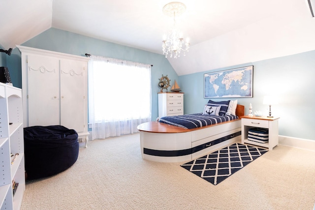 carpeted bedroom with a chandelier and vaulted ceiling