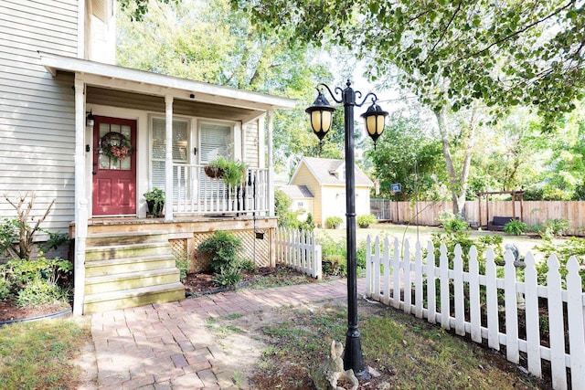 view of exterior entry with covered porch