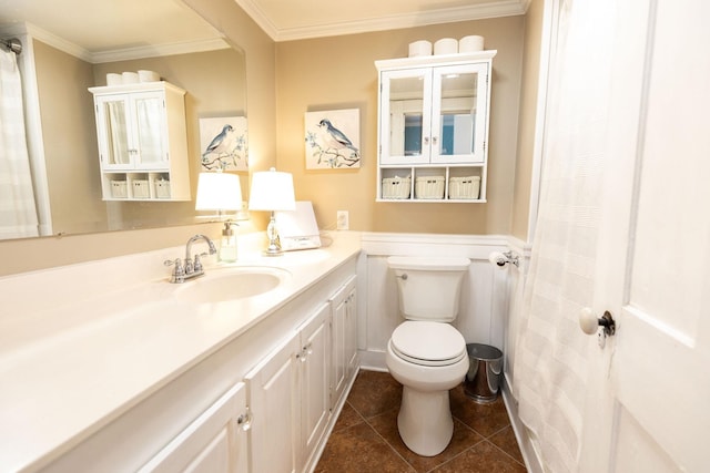 bathroom with tile patterned floors, vanity, toilet, and ornamental molding