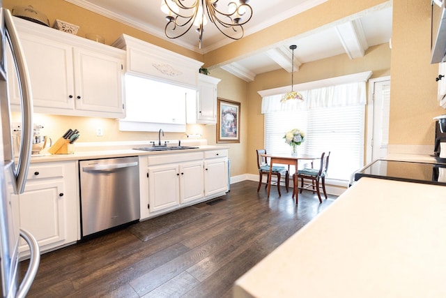 kitchen with appliances with stainless steel finishes, sink, beam ceiling, decorative light fixtures, and white cabinets