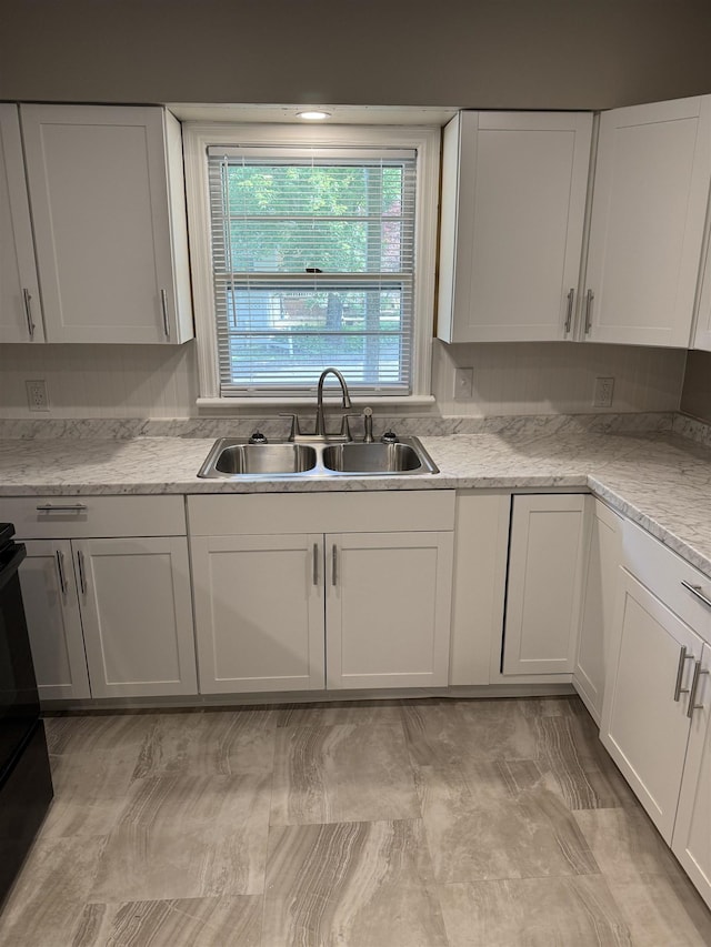  - kitchen with a sink and white cabinets