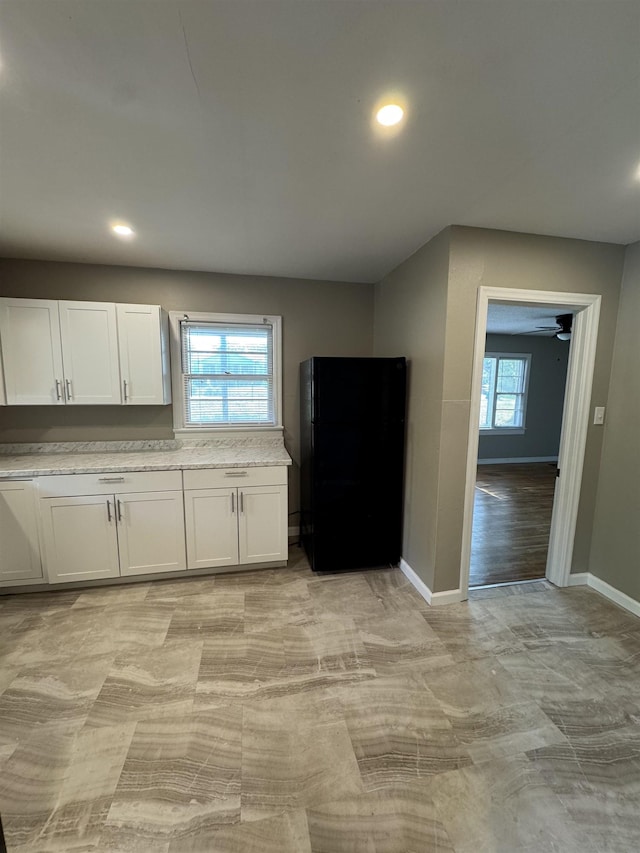  - kitchen featuring white cabinetry, baseboards, recessed lighting, freestanding refrigerator, and a ceiling fan