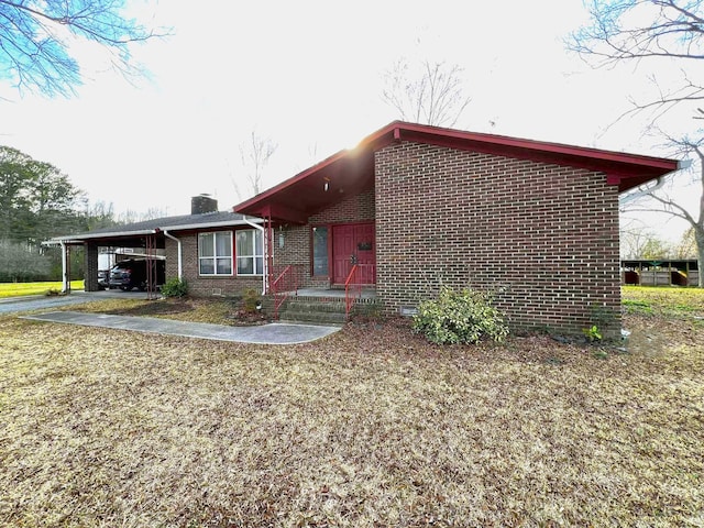 mid-century inspired home featuring a carport, a chimney, and brick siding
