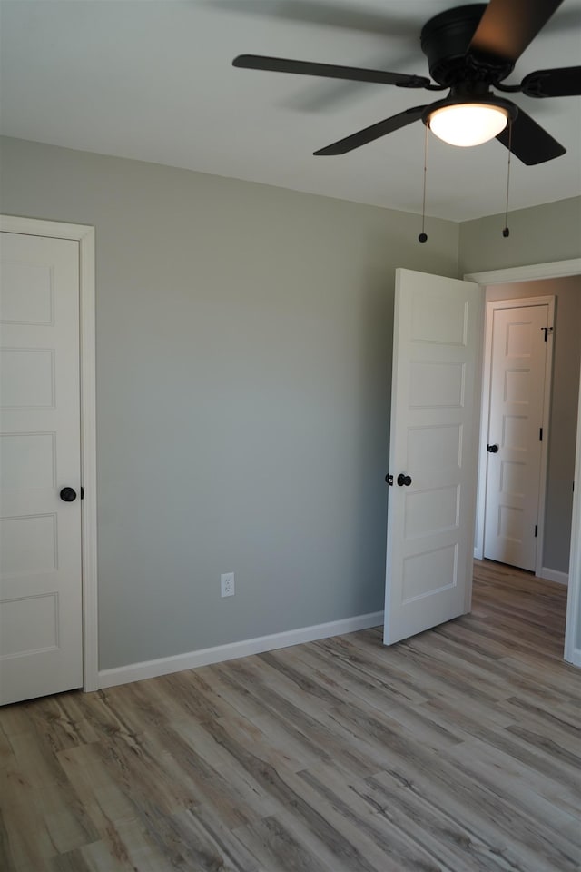 unfurnished room featuring ceiling fan and light hardwood / wood-style flooring