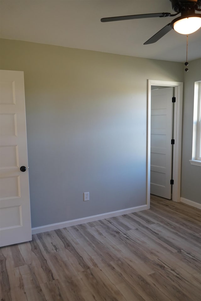 empty room with light hardwood / wood-style flooring and ceiling fan