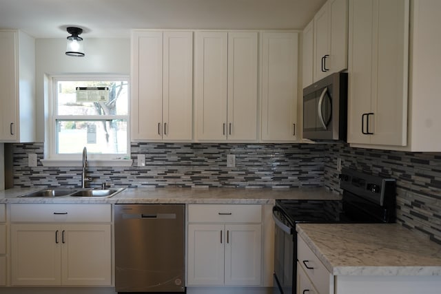 kitchen with black range with electric stovetop, dishwasher, sink, decorative backsplash, and white cabinets