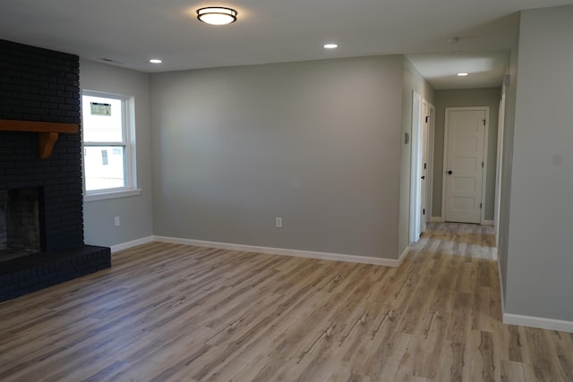 unfurnished living room featuring light hardwood / wood-style floors and a fireplace