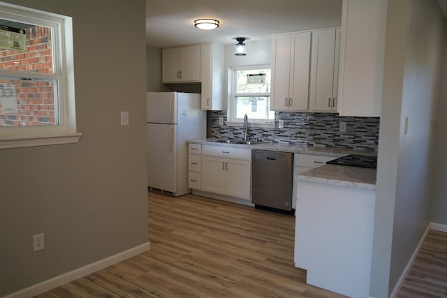 kitchen featuring white cabinetry, sink, dishwasher, and white refrigerator