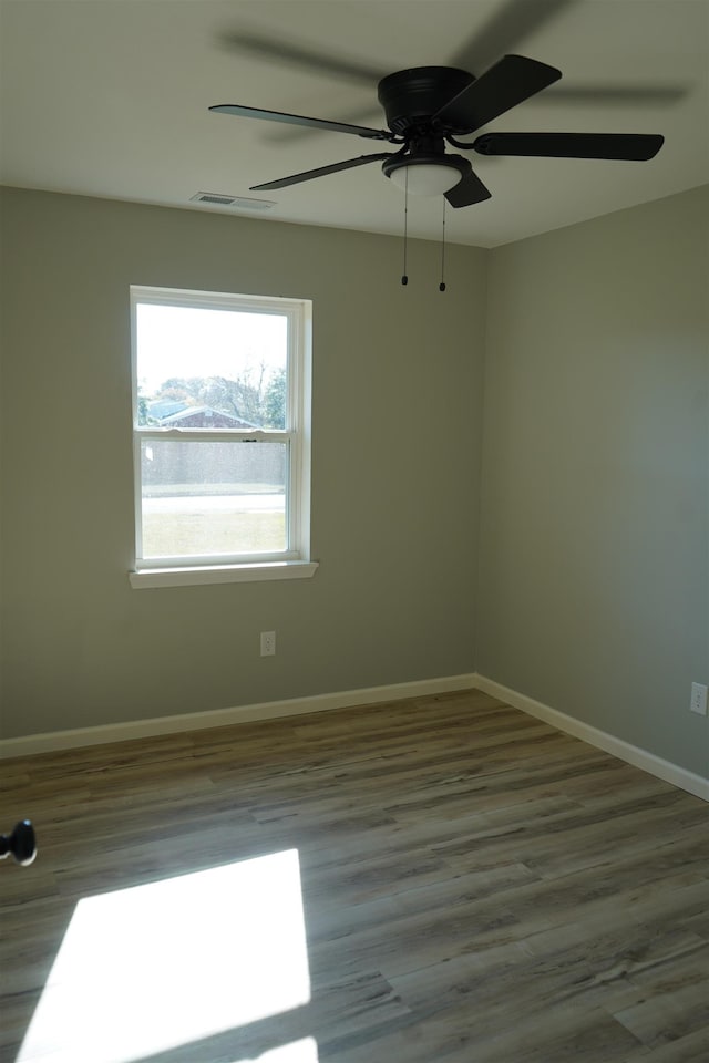 spare room featuring hardwood / wood-style floors and ceiling fan