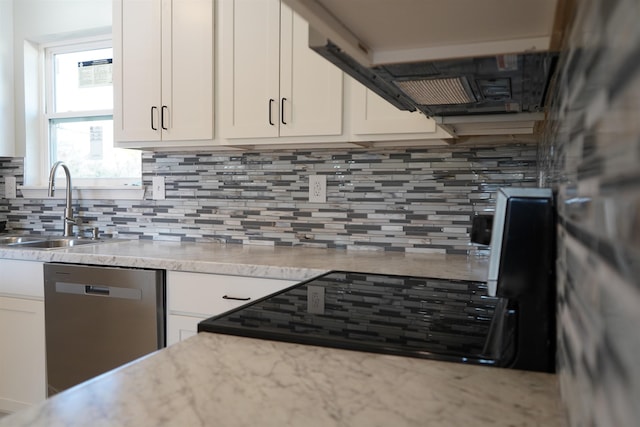 kitchen featuring dishwasher, backsplash, white cabinets, and sink