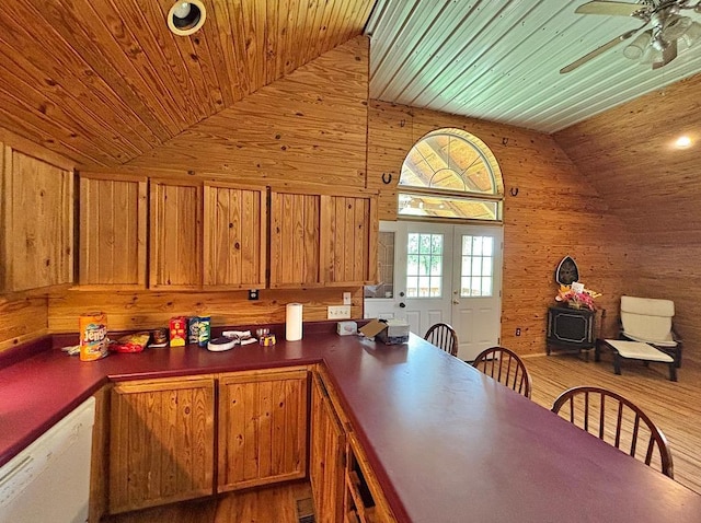  - kitchen with wooden ceiling, wood walls, white dishwasher, a ceiling fan, and dark countertops