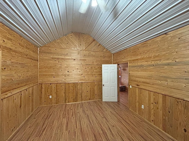  - bonus room with wood walls, vaulted ceiling, and wood finished floors