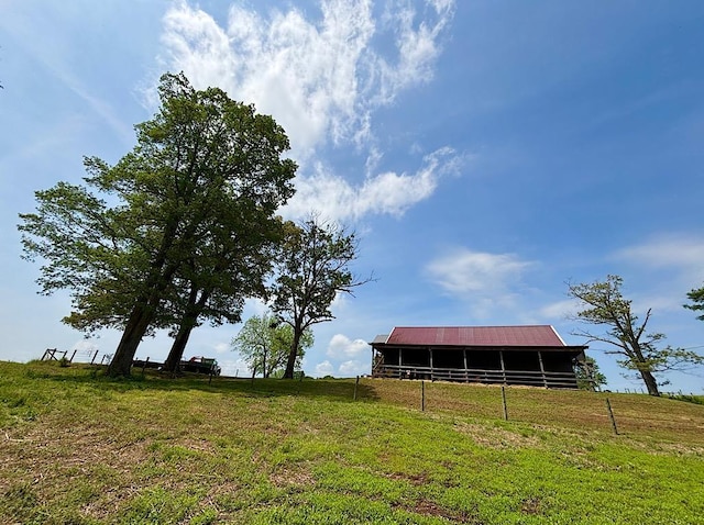  - view of grassy yard featuring a pole building and an outbuilding