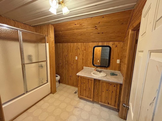  - bathroom with wooden walls, vanity, and combined bath / shower with glass door