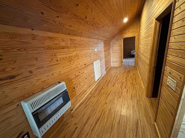  - bonus room with heating unit, wooden walls, lofted ceiling, light wood-style flooring, and wooden ceiling