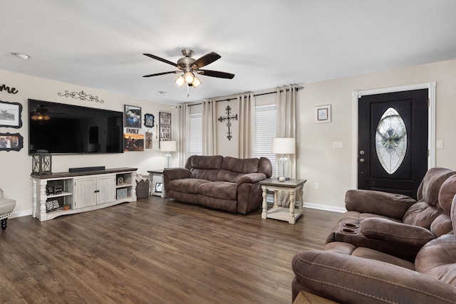 living room with dark wood-style floors, baseboards, and a ceiling fan