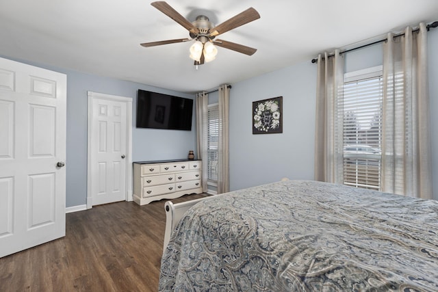 bedroom with ceiling fan, baseboards, and wood finished floors