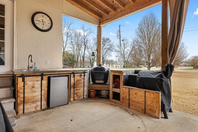 view of patio featuring exterior kitchen, a grill, and a sink