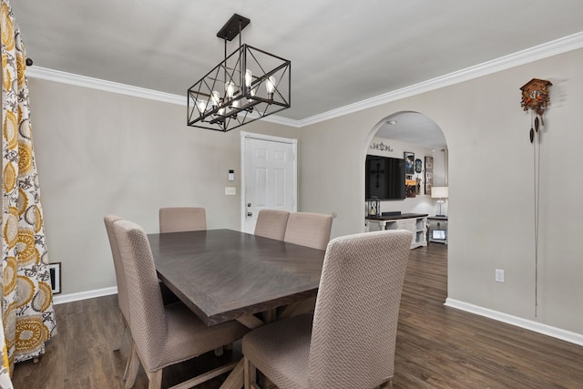 dining space with dark wood-type flooring, arched walkways, crown molding, and baseboards