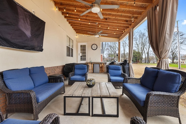 view of patio / terrace featuring ceiling fan, a sink, and an outdoor living space