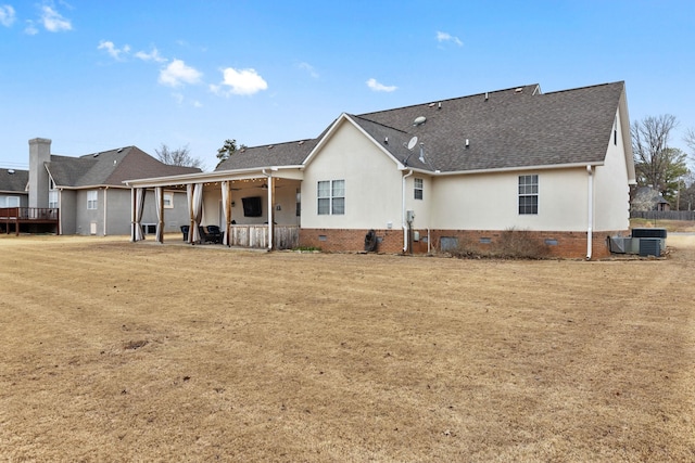 back of property featuring a shingled roof, crawl space, and a patio area