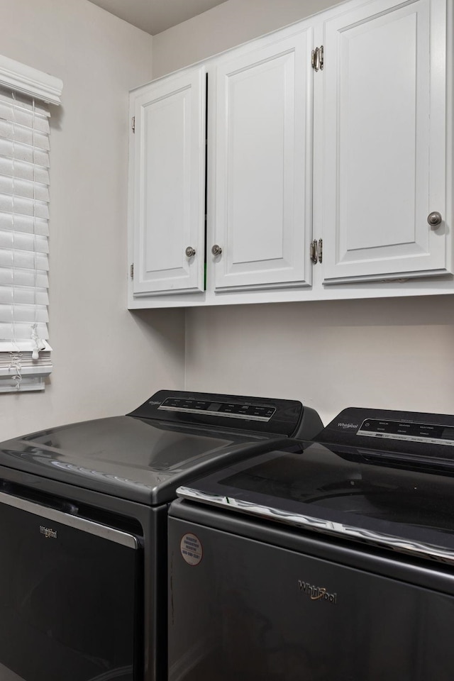 laundry area with washing machine and dryer and cabinet space