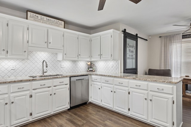 kitchen featuring dishwasher, ceiling fan, a peninsula, white cabinetry, and a sink