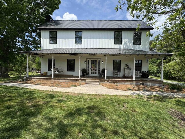  - view of front facade with a front lawn, covered porch, and metal roof
