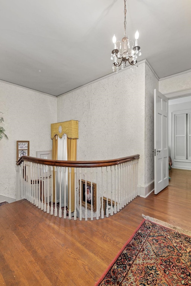 corridor with a chandelier and hardwood / wood-style flooring