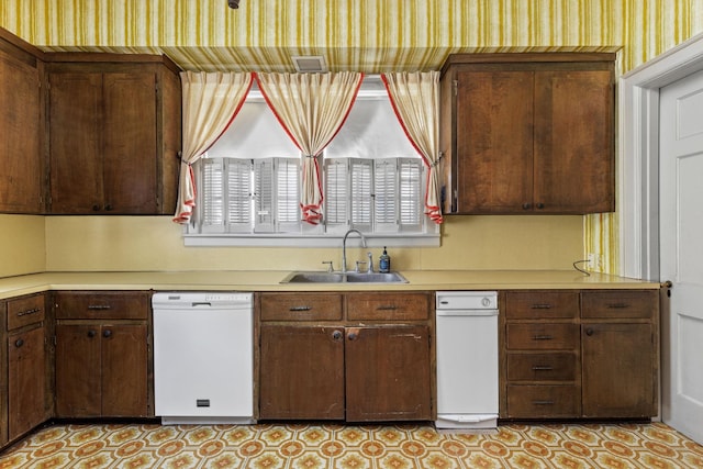 kitchen with dishwasher, dark brown cabinets, and sink