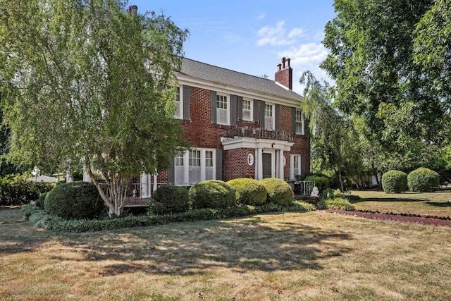 colonial-style house with a front yard