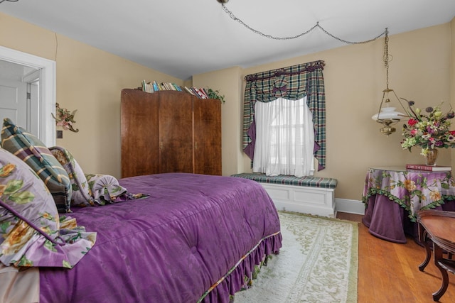 bedroom with hardwood / wood-style floors