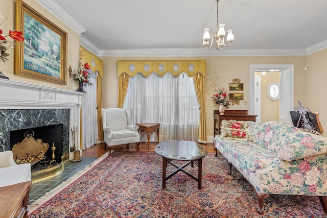 sitting room with hardwood / wood-style flooring, a premium fireplace, crown molding, and a chandelier