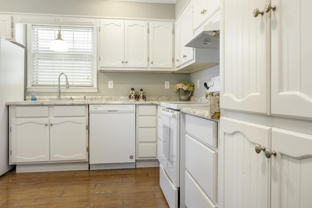  - kitchen featuring white appliances, under cabinet range hood, dark wood finished floors, a sink, and white cabinets