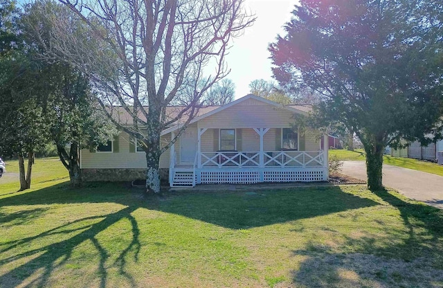 - view of front facade with a front lawn and covered porch